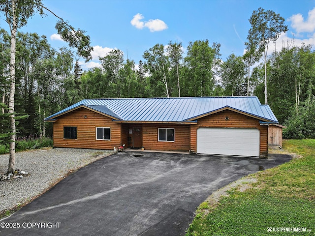 3600 N Fortune Cir, Wasilla, AK 99654 - view of front of property featuring faux log siding, driveway, a garage, and metal roof