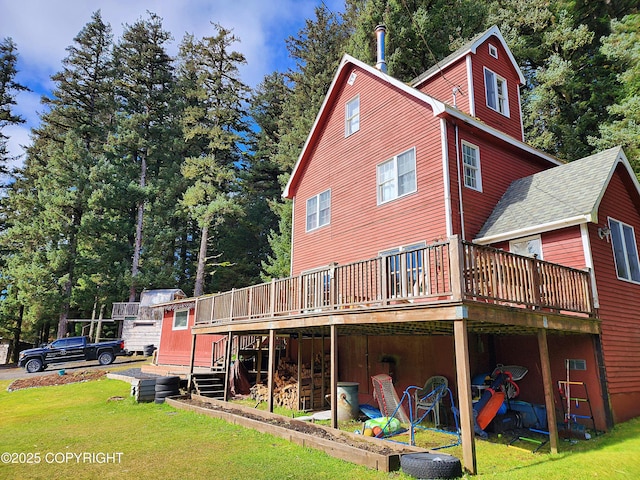 rear view of property with a lawn and a deck