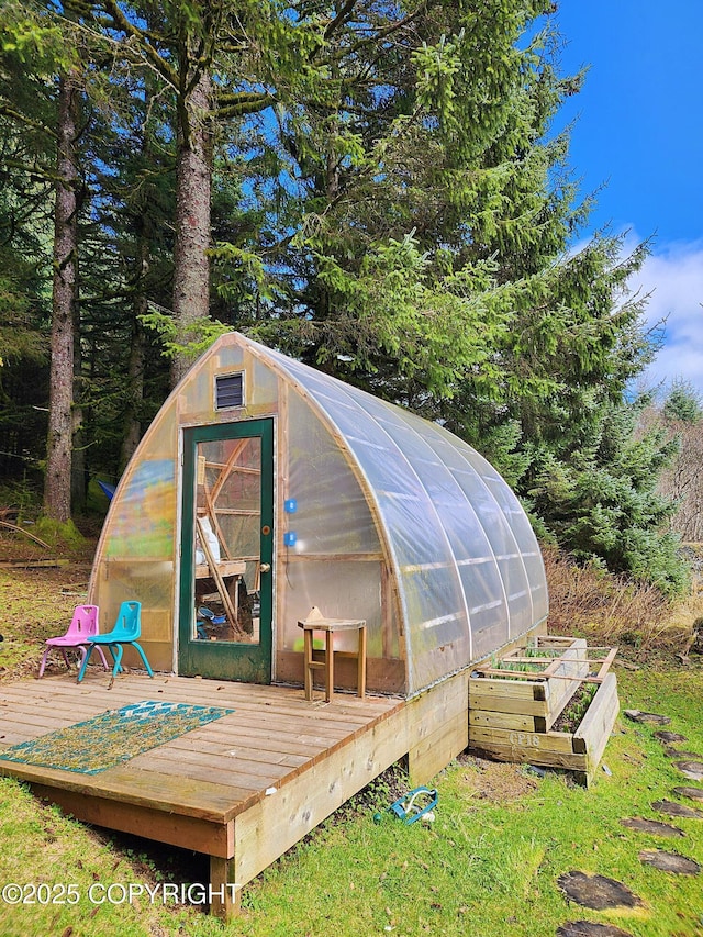 view of greenhouse with a garden