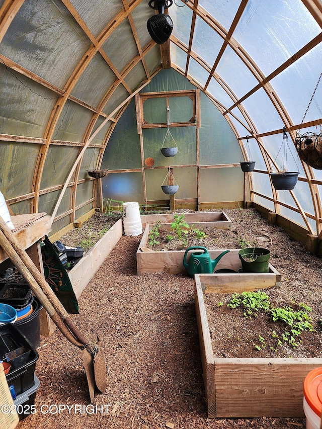 interior space with a vegetable garden, an outbuilding, and a greenhouse