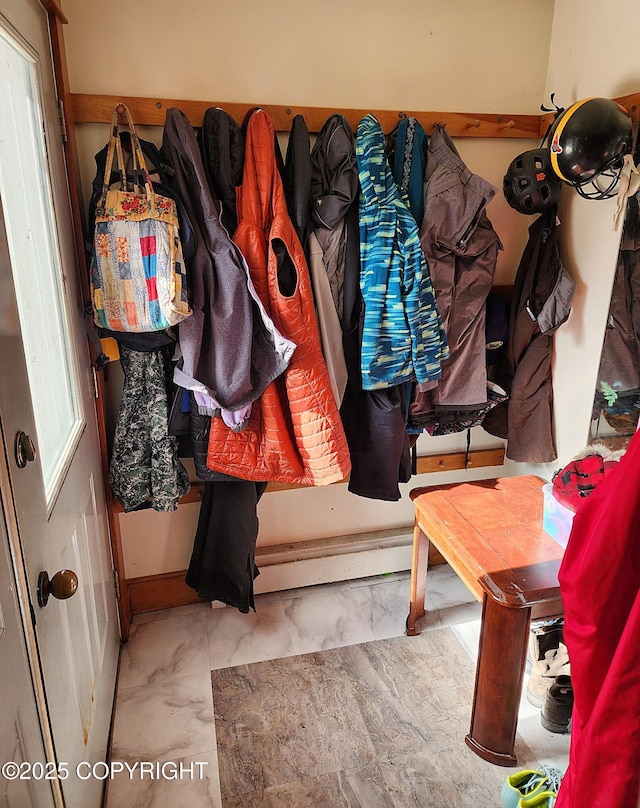 mudroom with marble finish floor and a baseboard radiator