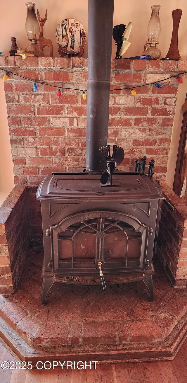 details with wood finished floors and a wood stove