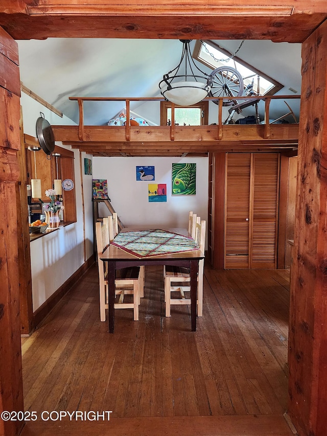 dining space with wood-type flooring, vaulted ceiling, and visible vents