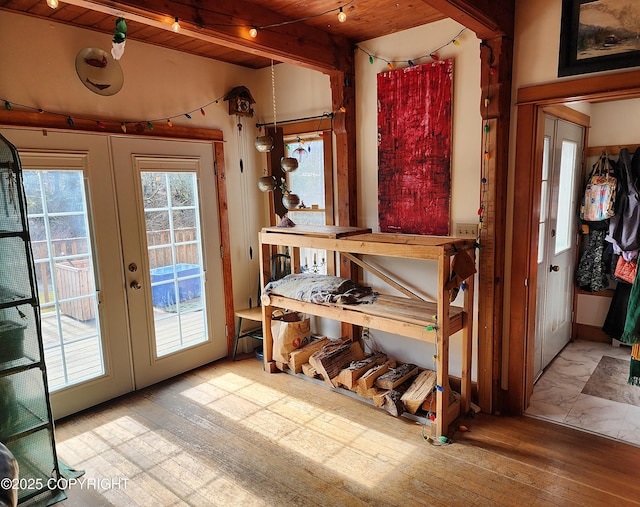 doorway with wood ceiling, hardwood / wood-style flooring, french doors, and beam ceiling