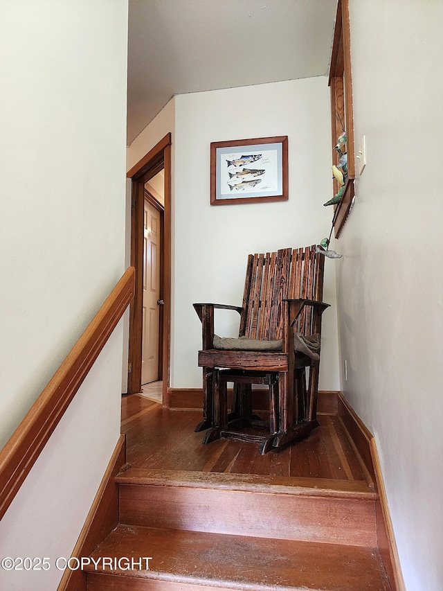 stairs featuring wood-type flooring and baseboards