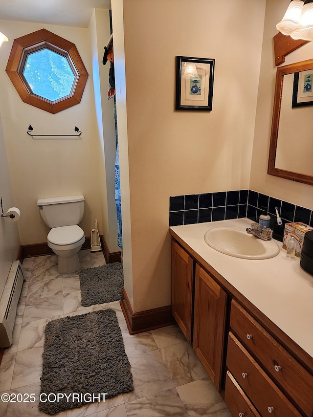 full bathroom with a baseboard heating unit, baseboards, marble finish floor, and vanity