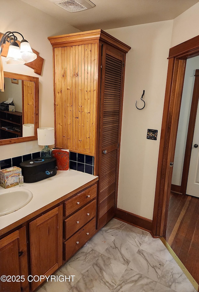 bathroom featuring marble finish floor, vanity, and visible vents