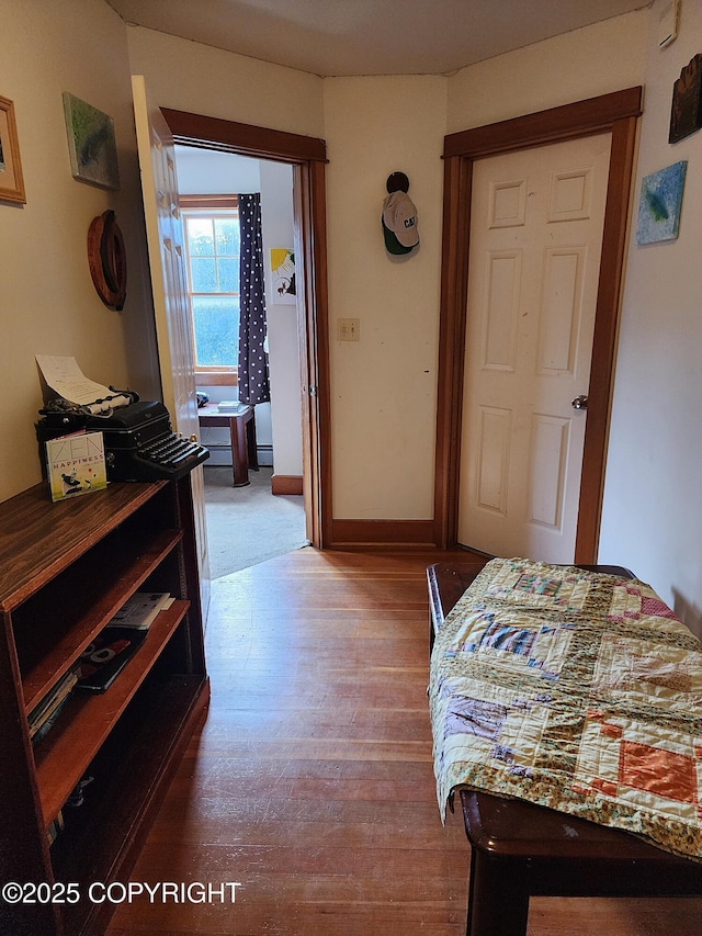 bedroom with wood finished floors and baseboards