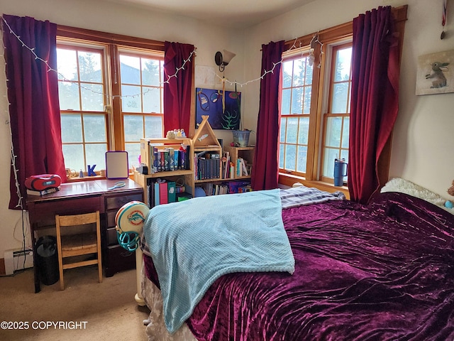 carpeted bedroom with a baseboard heating unit