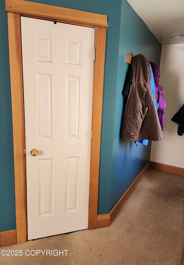 interior space featuring carpet and baseboards