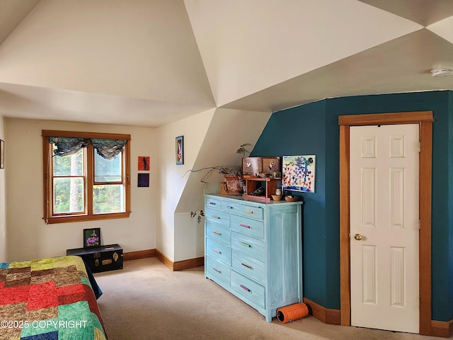 bedroom with baseboards, lofted ceiling, and light colored carpet