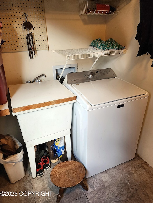clothes washing area featuring washer / dryer and laundry area