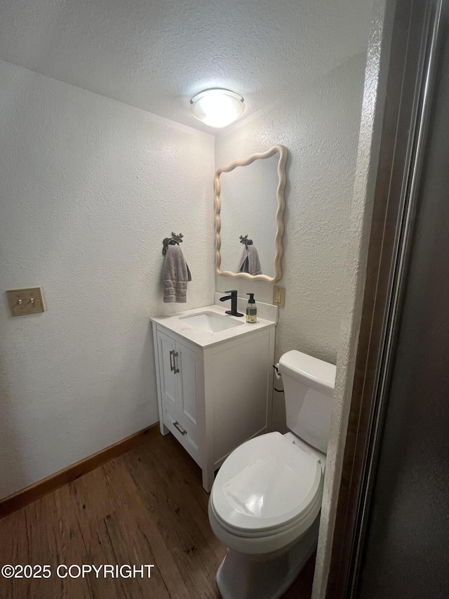 6331 E Pike Ave, Wasilla, AK 99654 - half bathroom with wood finished floors, toilet, vanity, and baseboards