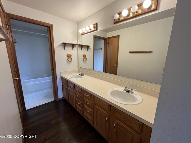 603 Rambler St, Petersburg, AK 99833 - full bath featuring wood finished floors, double vanity, and a bathtub