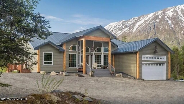 21899 Sterling Hwy, Cooper Landing, AK 99572 - view of front of house with driveway, metal roof, a mountain view, and an attached garage