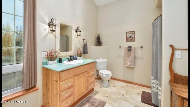 21899 Sterling Hwy, Cooper Landing, AK 99572 - bathroom with toilet, vanity, plenty of natural light, and baseboards