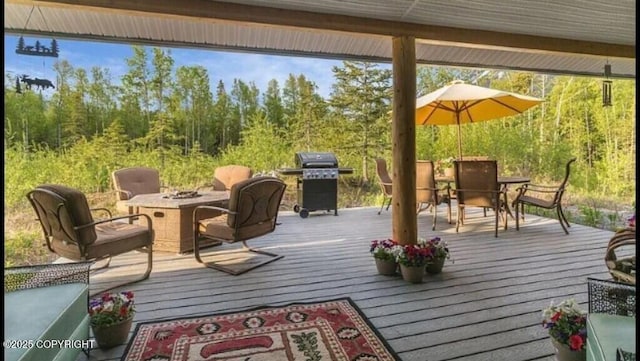 21899 Sterling Hwy, Cooper Landing, AK 99572 - deck featuring a grill, an outdoor fire pit, and outdoor dining area