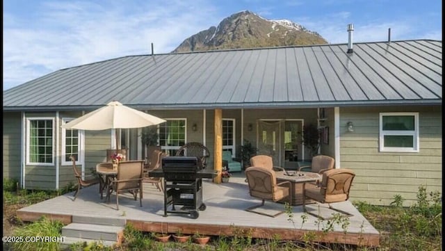 21899 Sterling Hwy, Cooper Landing, AK 99572 - back of property featuring metal roof, a standing seam roof, a fire pit, and a deck with mountain view