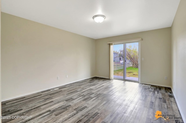 unfurnished room featuring wood finished floors and baseboards