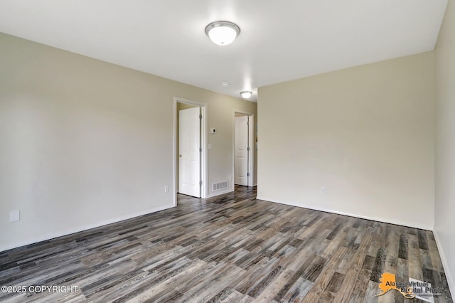 unfurnished room featuring wood finished floors and baseboards