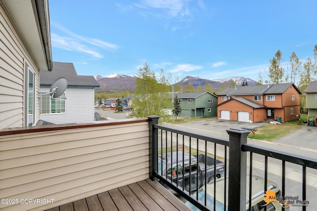 wooden deck featuring a mountain view and a residential view