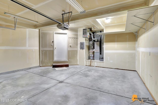 garage with a garage door opener and electric panel