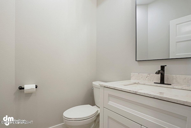6485 Prominence Pointe Dr, Anchorage, AK 99516 - half bathroom with toilet, vanity, and baseboards