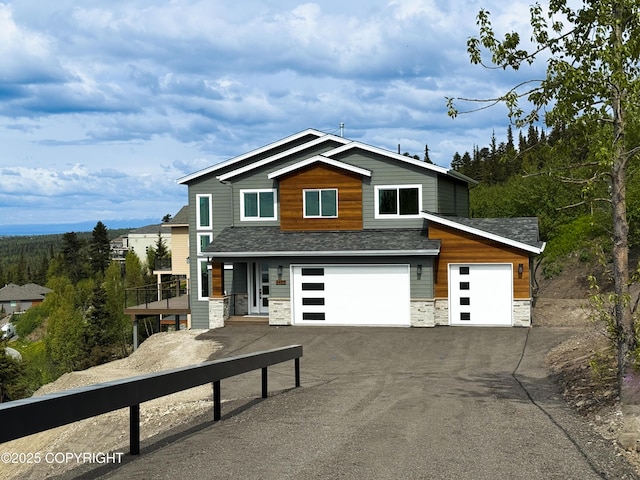 6485 Prominence Pointe Dr, Anchorage, AK 99516 - contemporary home with stone siding, driveway, roof with shingles, and an attached garage