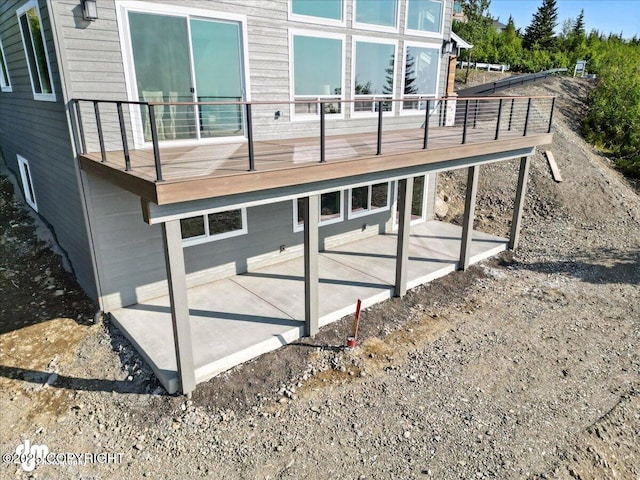 6485 Prominence Pointe Dr, Anchorage, AK 99516 - view of home's exterior with a patio and a wooden deck