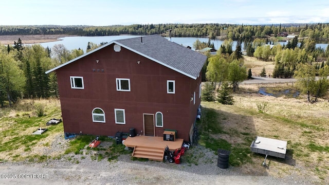 53160 Stol Rd, Clam Gulch, AK 99568 - view of side of property featuring a forest view, a shingled roof, and a deck with water view