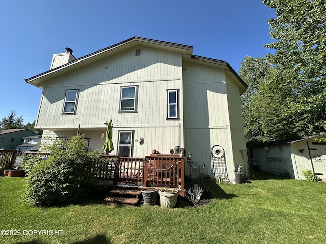 2000 Wenmatt Cir, Anchorage, AK 99517 - back of property featuring a chimney, a lawn, and a deck