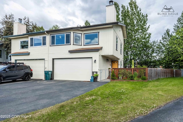 2000 Wenmatt Cir, Anchorage, AK 99517 - view of front of property featuring a chimney, a garage, and asphalt driveway