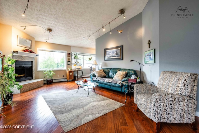 2000 Wenmatt Cir, Anchorage, AK 99517 - living area with rail lighting, wood finished floors, and a premium fireplace