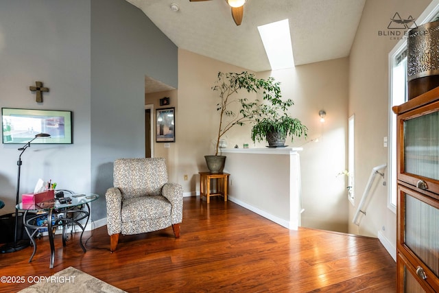 2000 Wenmatt Cir, Anchorage, AK 99517 - living area featuring wood finished floors, vaulted ceiling, a ceiling fan, and a skylight