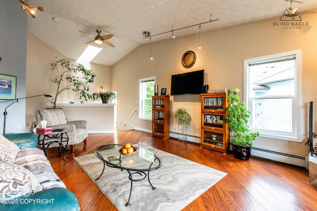 2000 Wenmatt Cir, Anchorage, AK 99517 - living area with baseboard heating, ceiling fan, wood finished floors, a textured ceiling, and lofted ceiling