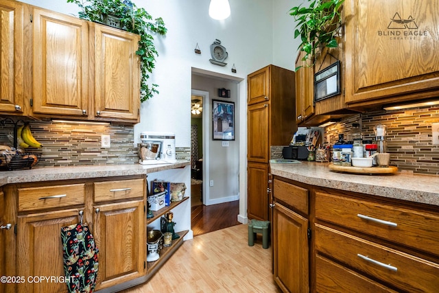2000 Wenmatt Cir, Anchorage, AK 99517 - kitchen featuring decorative backsplash, light countertops, and light wood-style floors