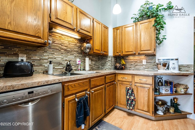 2000 Wenmatt Cir, Anchorage, AK 99517 - kitchen featuring dishwasher, tasteful backsplash, light wood-style flooring, light countertops, and brown cabinetry