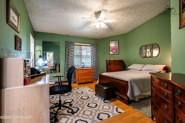 2000 Wenmatt Cir, Anchorage, AK 99517 - bedroom featuring a textured ceiling, wood finished floors, an office area, and ceiling fan