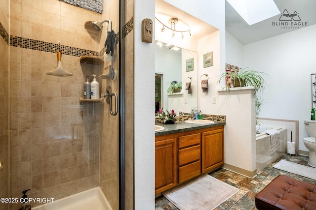 2000 Wenmatt Cir, Anchorage, AK 99517 - full bath with a skylight, double vanity, a tile shower, a garden tub, and stone finish floors