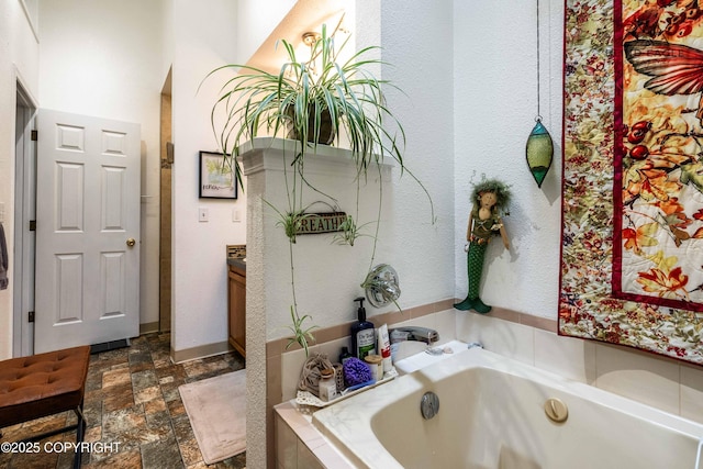 2000 Wenmatt Cir, Anchorage, AK 99517 - bathroom with a garden tub and stone finish flooring