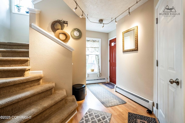 2000 Wenmatt Cir, Anchorage, AK 99517 - entrance foyer with baseboard heating, rail lighting, stairway, and a textured wall