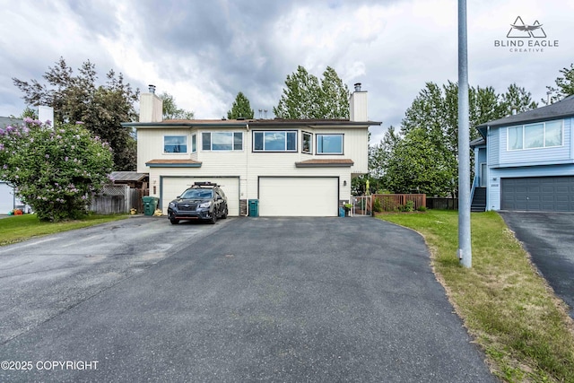2000 Wenmatt Cir, Anchorage, AK 99517 - view of front facade featuring a chimney, a garage, and driveway