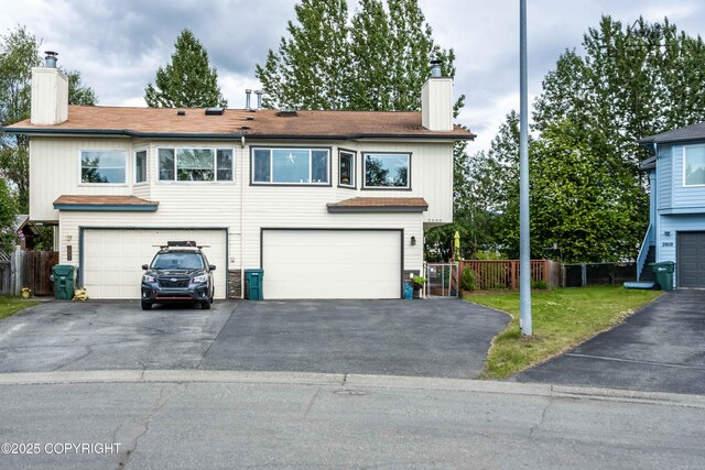 2000 Wenmatt Cir, Anchorage, AK 99517 - multi unit property with a chimney, an attached garage, and driveway