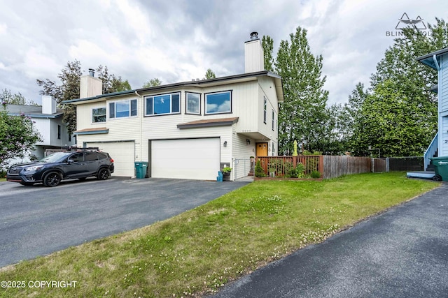 2000 Wenmatt Cir, Anchorage, AK 99517 - view of front of house with a chimney, an attached garage, and driveway