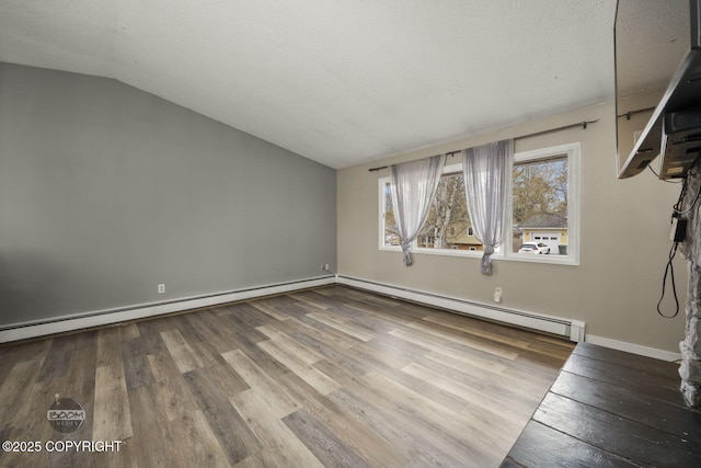 1851 E 53rd Ave, Anchorage, AK 99507 - unfurnished living room featuring baseboards, a baseboard heating unit, wood finished floors, and lofted ceiling