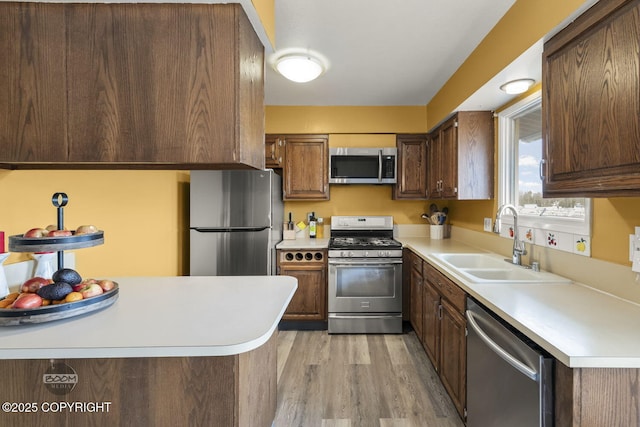 1851 E 53rd Ave, Anchorage, AK 99507 - kitchen with a sink, light countertops, light wood-style floors, and stainless steel appliances