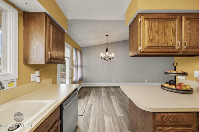 1851 E 53rd Ave, Anchorage, AK 99507 - kitchen with brown cabinetry, stainless steel dishwasher, vaulted ceiling, light countertops, and light wood-style flooring