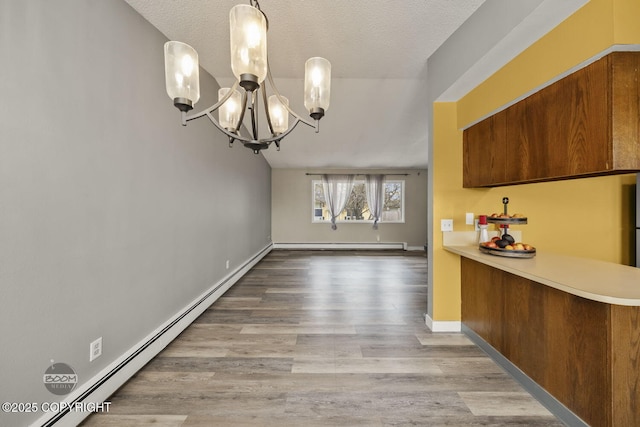 1851 E 53rd Ave, Anchorage, AK 99507 - unfurnished dining area featuring a baseboard radiator, wood finished floors, and a chandelier