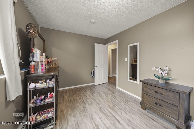1851 E 53rd Ave, Anchorage, AK 99507 - interior space with baseboards, a textured ceiling, and wood finished floors