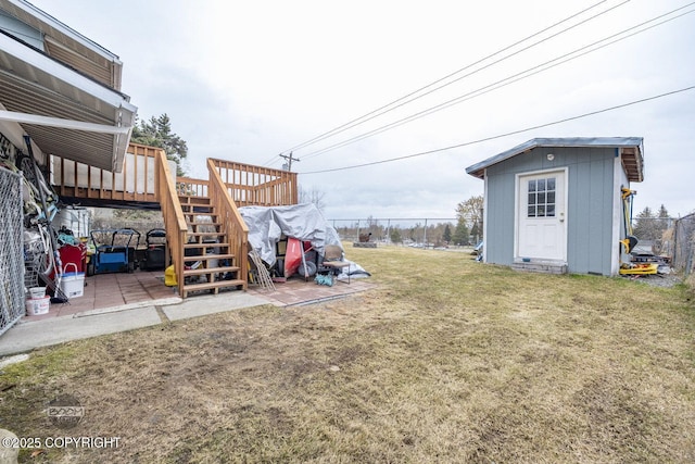 1851 E 53rd Ave, Anchorage, AK 99507 - view of yard with stairs, a storage shed, a wooden deck, an outbuilding, and a patio